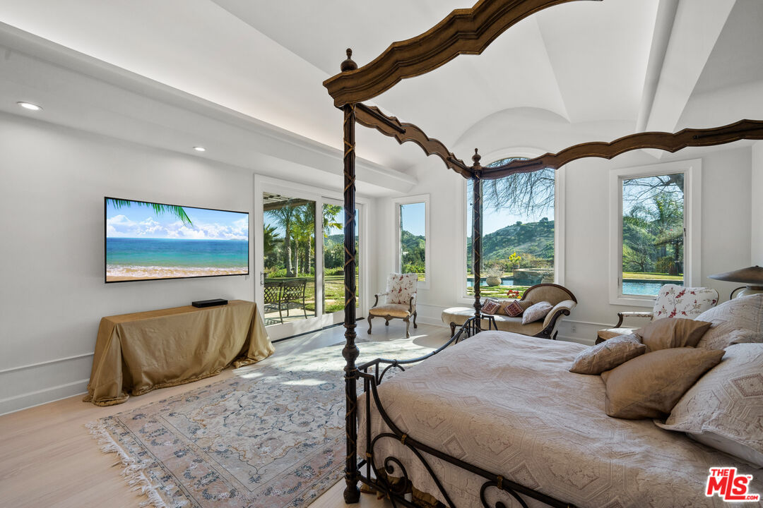 23318 Park Colombo Calabasas, CA 91302 - Photo 17 of 36 a bedroom with furniture and a large window