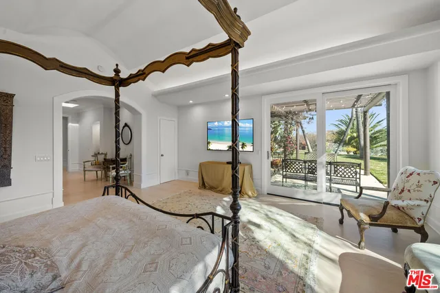 a bedroom with furniture and a window