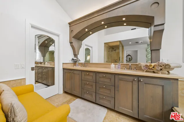 a en suite bathroom with a double vanity sink and a mirror