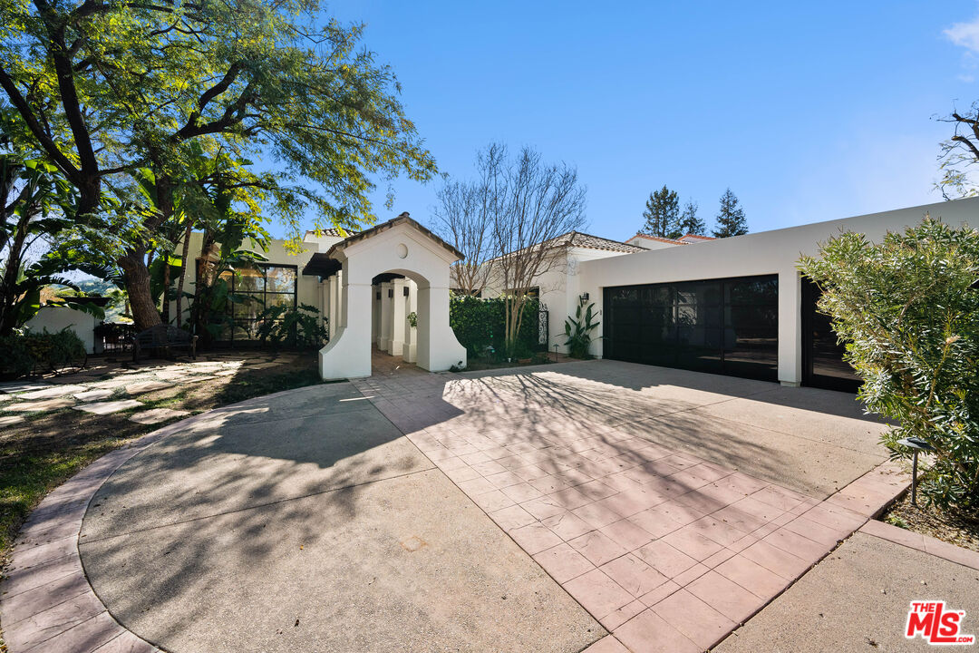 23318 Park Colombo Calabasas, CA 91302 - Photo 2 of 36 a front view of a house with a yard and garage