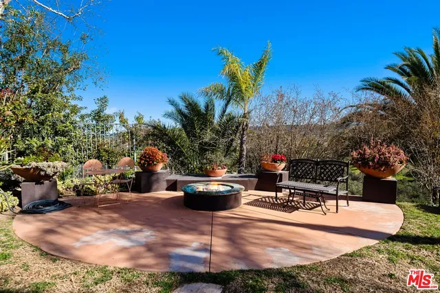 a view of a backyard with sitting area