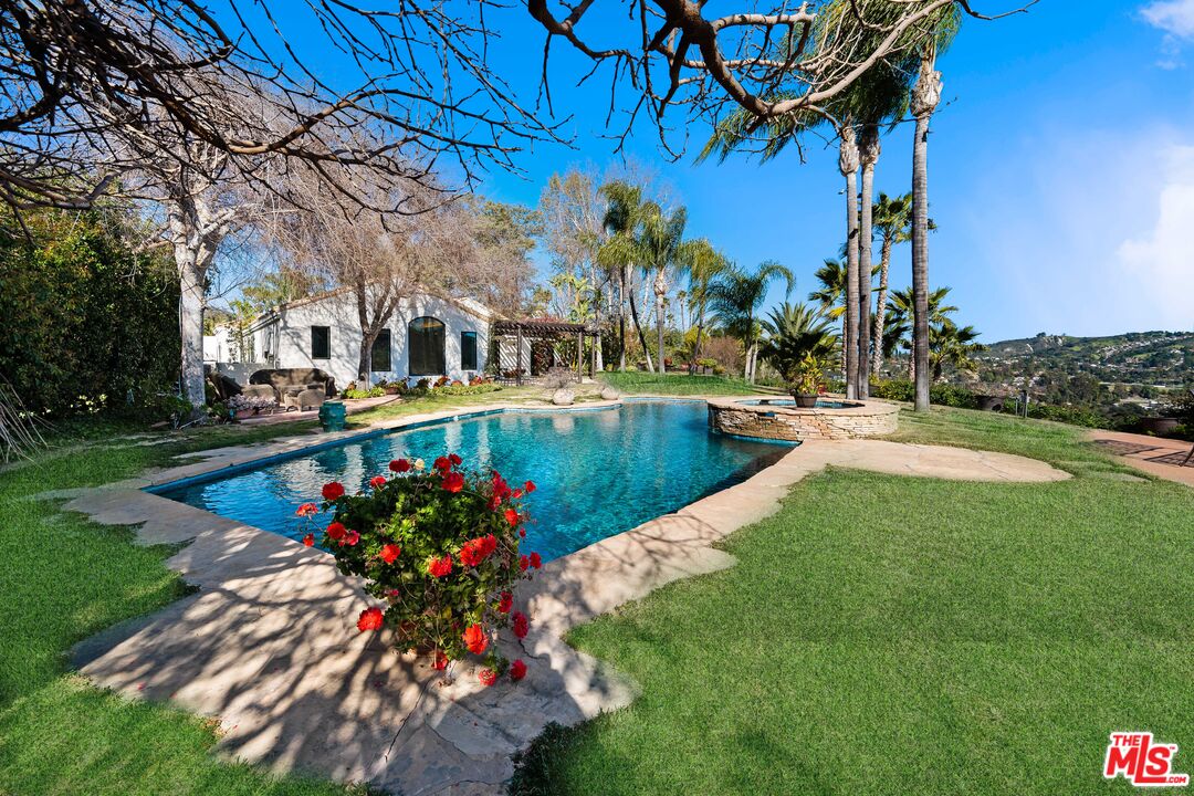 23318 Park Colombo Calabasas, CA 91302 - Photo 30 of 36 a view of a house with a yard