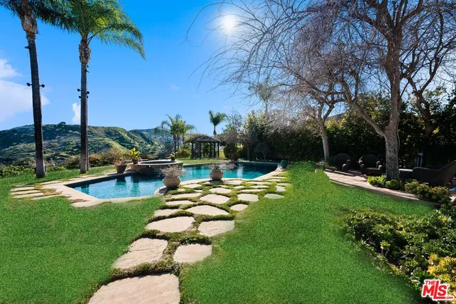 a view of a swimming pool with a patio