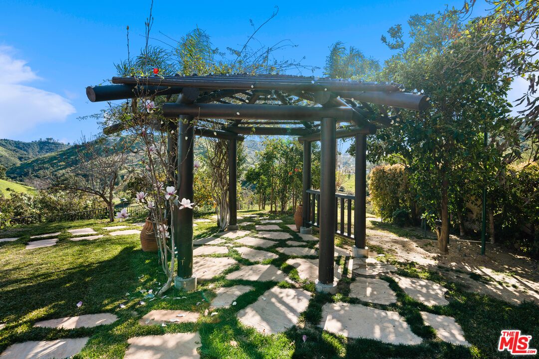 23318 Park Colombo Calabasas, CA 91302 - Photo 35 of 36 a view of a patio with table and chairs potted plants with large tree