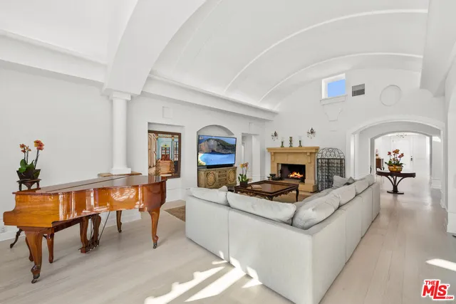 a living room with fireplace furniture and a fireplace