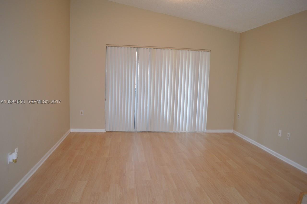 2011 Renaissance Boulevard, Unit 201 Miramar, FL 33025 - Photo 13 of 22 a view of an empty room with a window
