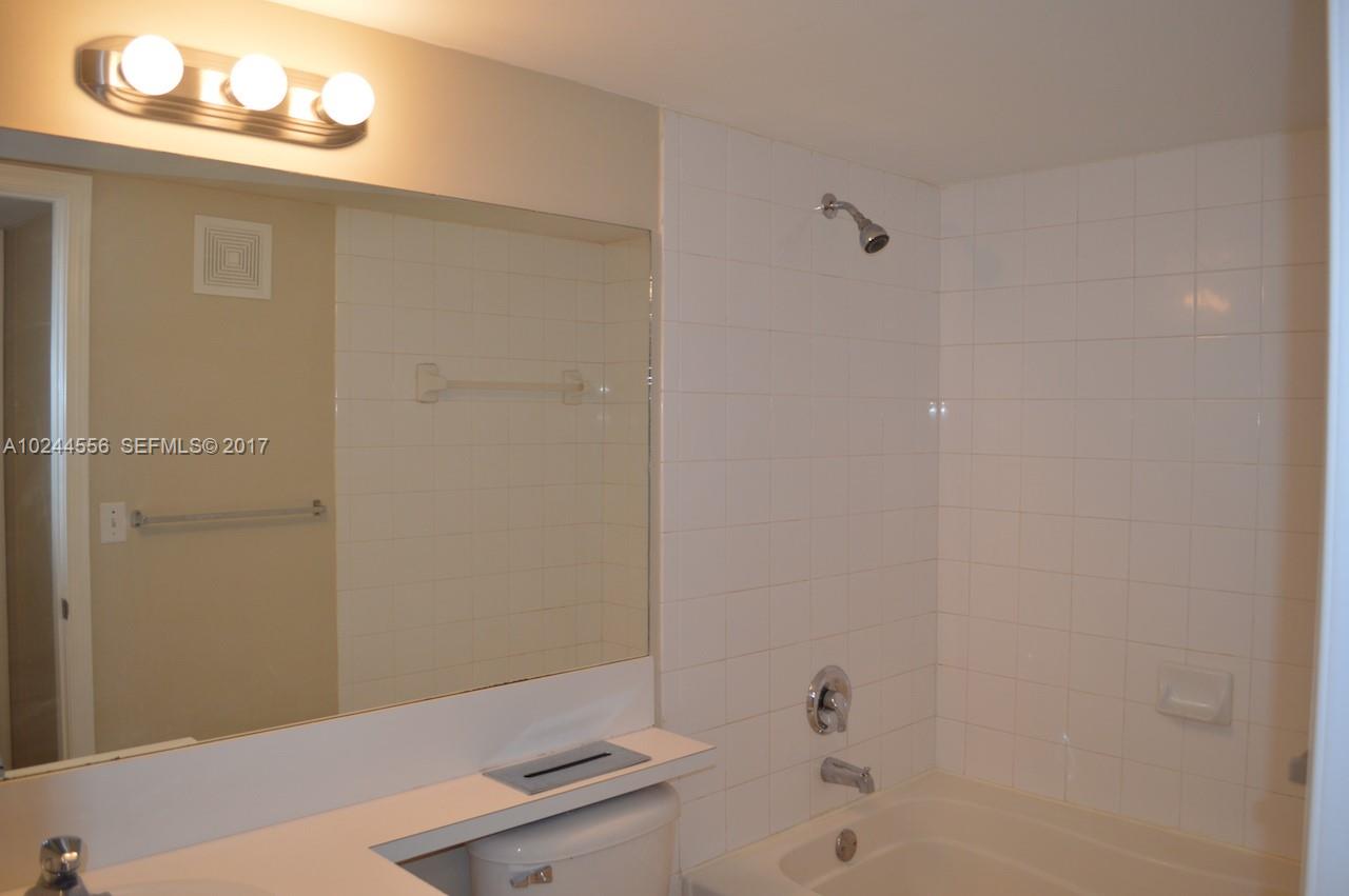 2011 Renaissance Boulevard, Unit 201 Miramar, FL 33025 - Photo 18 of 22 a bathroom with a sink a toilet and shower