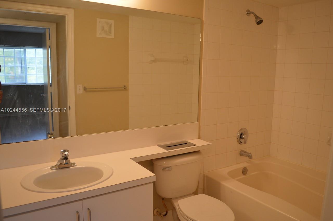 2011 Renaissance Boulevard, Unit 201 Miramar, FL 33025 - Photo 19 of 22 a bathroom with a sink toilet and shower