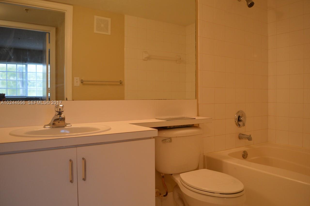 2011 Renaissance Boulevard, Unit 201 Miramar, FL 33025 - Photo 20 of 22 a bathroom with a sink a toilet and bathtub