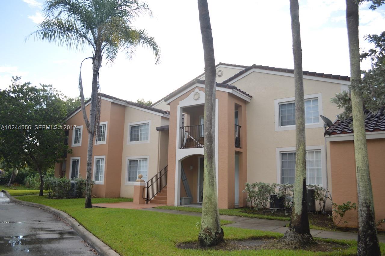 2011 Renaissance Boulevard, Unit 201 Miramar, FL 33025 - Photo 21 of 22 a front view of a house with a garden and plants