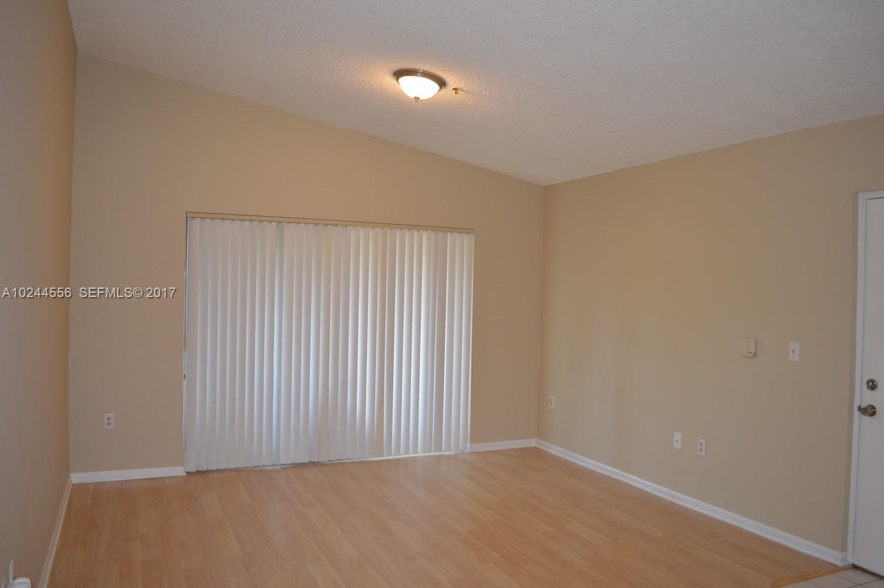 2011 Renaissance Boulevard, Unit 201 Miramar, FL 33025 - Photo 4 of 22 a view of an empty room with a window
