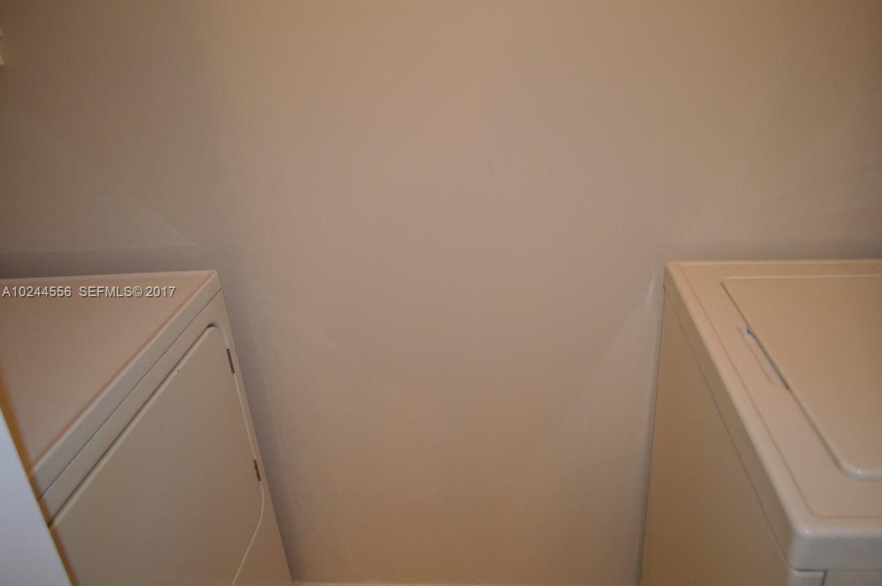 2011 Renaissance Boulevard, Unit 201 Miramar, FL 33025 - Photo 9 of 22 a utility room with dryer and washer