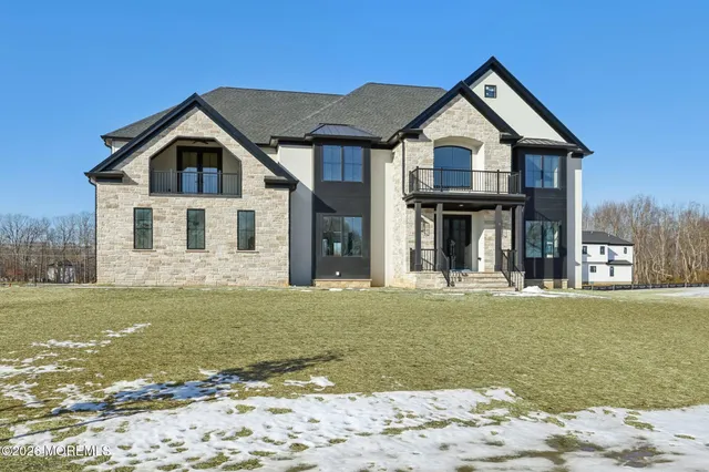 a front view of a house with a garden and yard