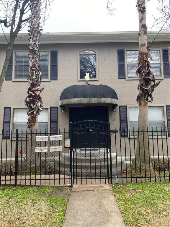 315 Branard Street, Unit 4 Houston, TX 77006 - Photo 2 of 20 a front view of a house with a garden