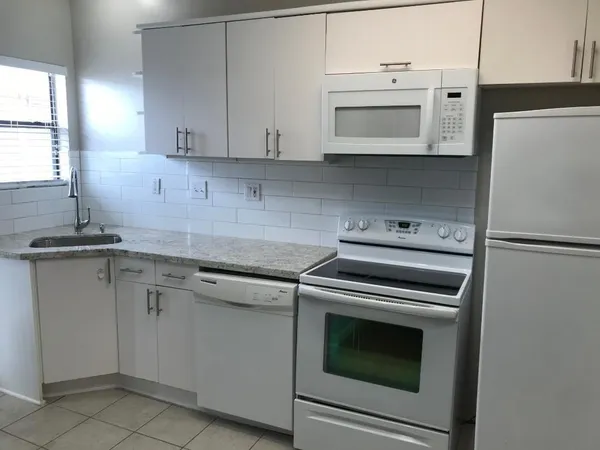 a kitchen with cabinets stainless steel appliances and a sink