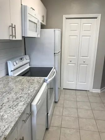 a kitchen with stainless steel appliances granite countertop a sink stove and cabinets