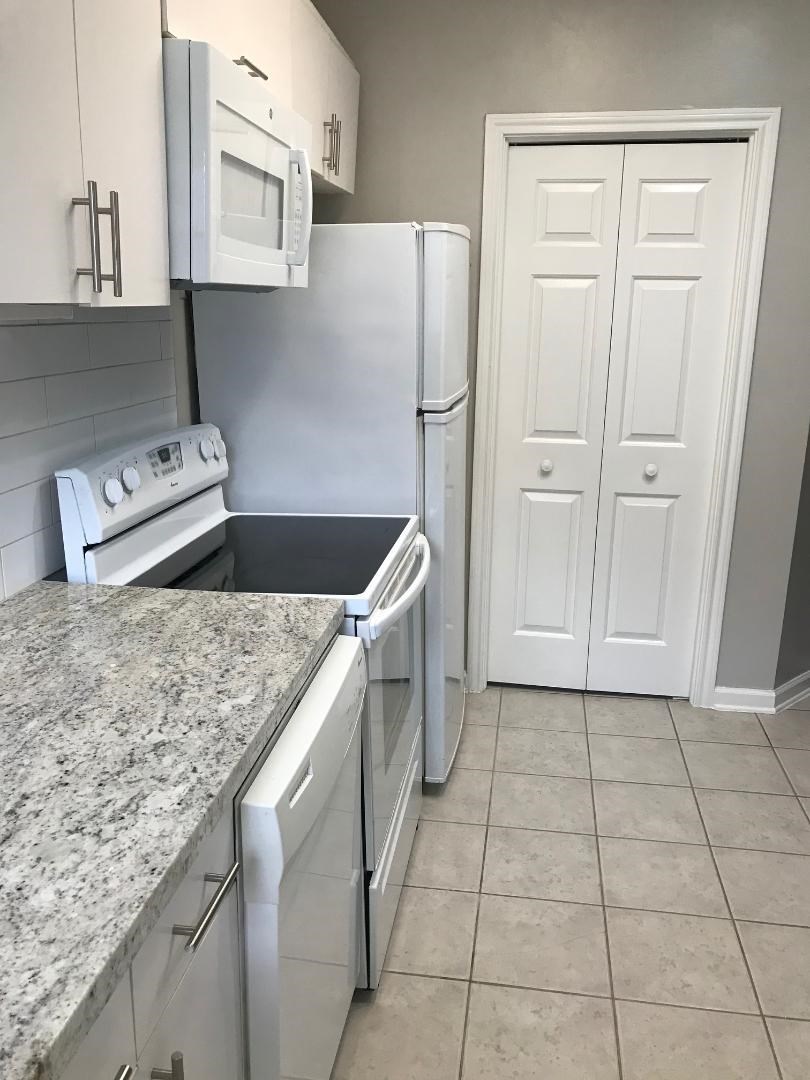 315 Branard Street, Unit 4 Houston, TX 77006 - Photo 4 of 20 a kitchen with stainless steel appliances granite countertop a sink stove and cabinets