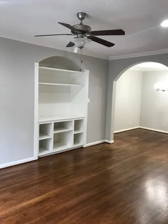 a view of a room with wooden floor