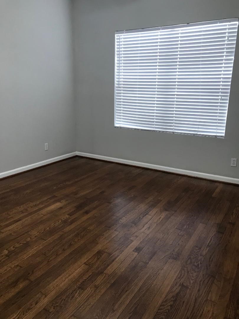 315 Branard Street, Unit 4 Houston, TX 77006 - Photo 10 of 20 a view of an empty room with wooden floor and a window