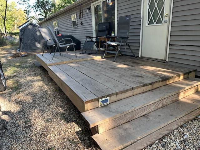 1198 Old Porter Road Porter, IN 46304 - Photo 18 of 22 a view of a backyard with chairs and wooden fence