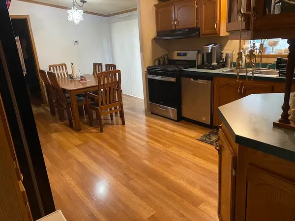 a kitchen with granite countertop sink stove and cabinets