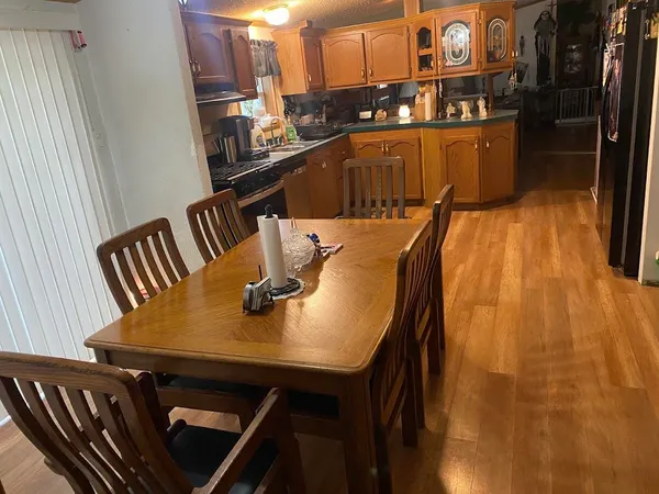 a view of a dining room with furniture and wooden floor