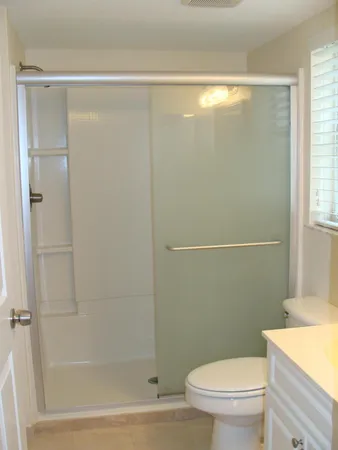 a bathroom with a shower a toilet and a sink