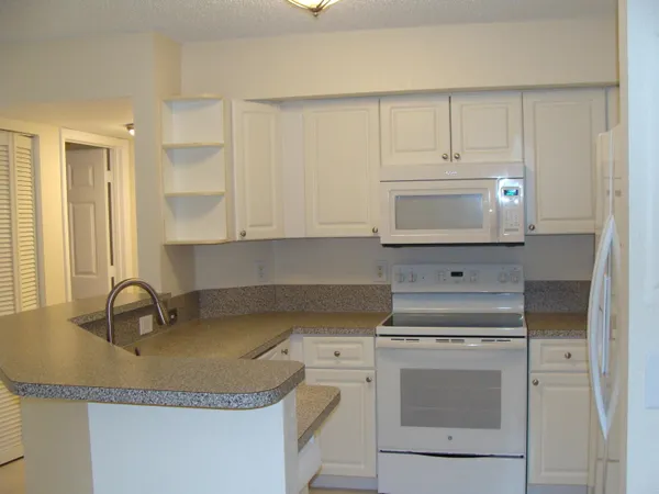 a kitchen with a sink stove and cabinets