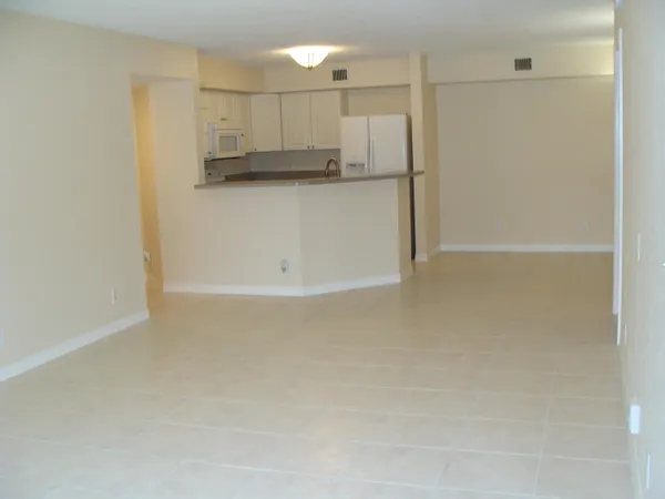 a view of a refrigerator in kitchen and a white cabinet