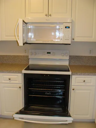 a stove top oven sitting inside of a kitchen