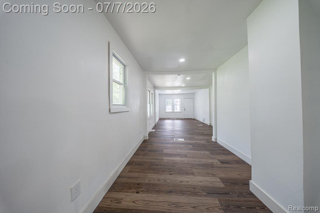 18486 Trinity Street Detroit, MI 48219 - Photo 6 of 19 Elongated interior corridor featuring wood-finish flooring, crisp white walls, and a recessed lighting fixture