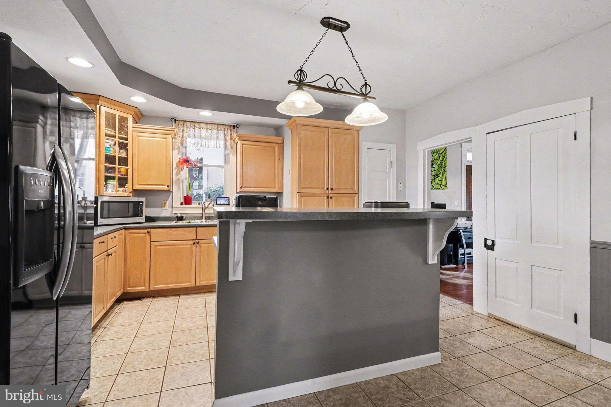 153 East Main Street Biglerville, PA 17307 - Photo 11 of 39 a kitchen with stainless steel appliances granite countertop a refrigerator a sink dishwasher a stove and a dining table with wooden floor
