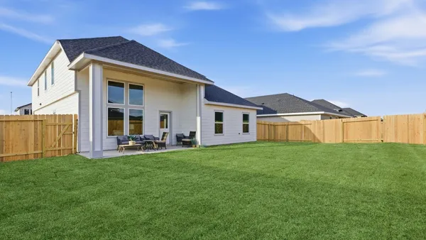 a view of a house with backyard porch and garden