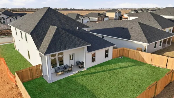 a view of a house with backyard porch and sitting area