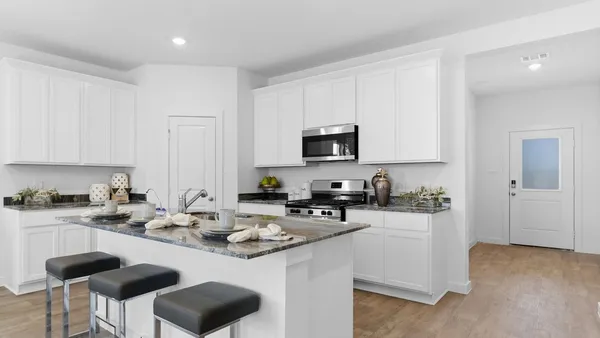 a kitchen with a sink stove top oven and microwave