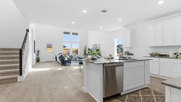 a kitchen with sink and cabinets