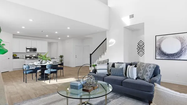 a living room with furniture kitchen and a table
