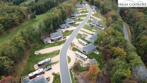 an aerial view of a house a yard and mountain