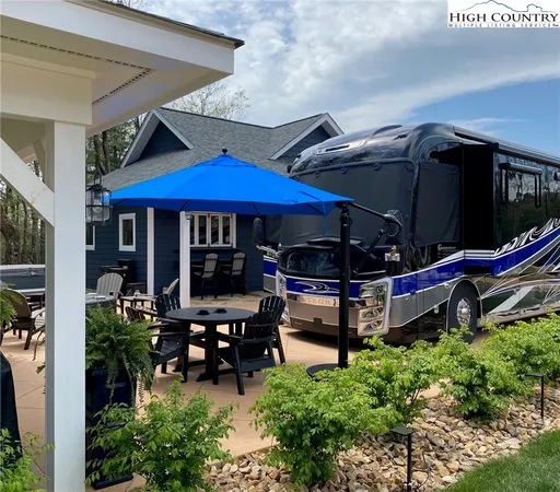 a view of a chairs and tables in patio and a blue umbrella
