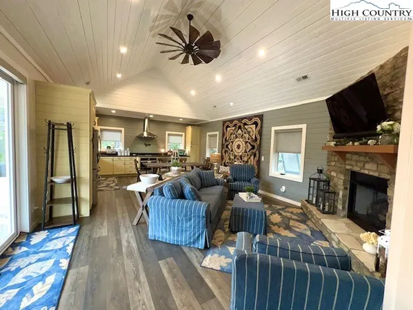 a living room with furniture fireplace and flat screen tv