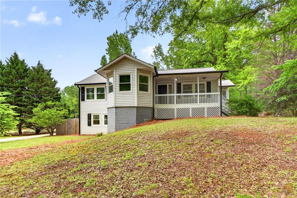 a front view of a house with a garden
