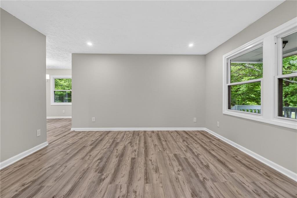 7630 Rico Road Palmetto, GA 30268 - Photo 12 of 53 an empty room with wooden floor and windows