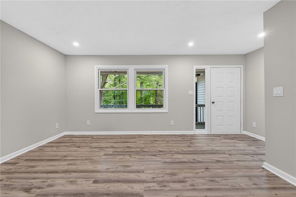 7630 Rico Road Palmetto, GA 30268 - Photo 13 of 53 a view of an empty room with wooden floor and a window