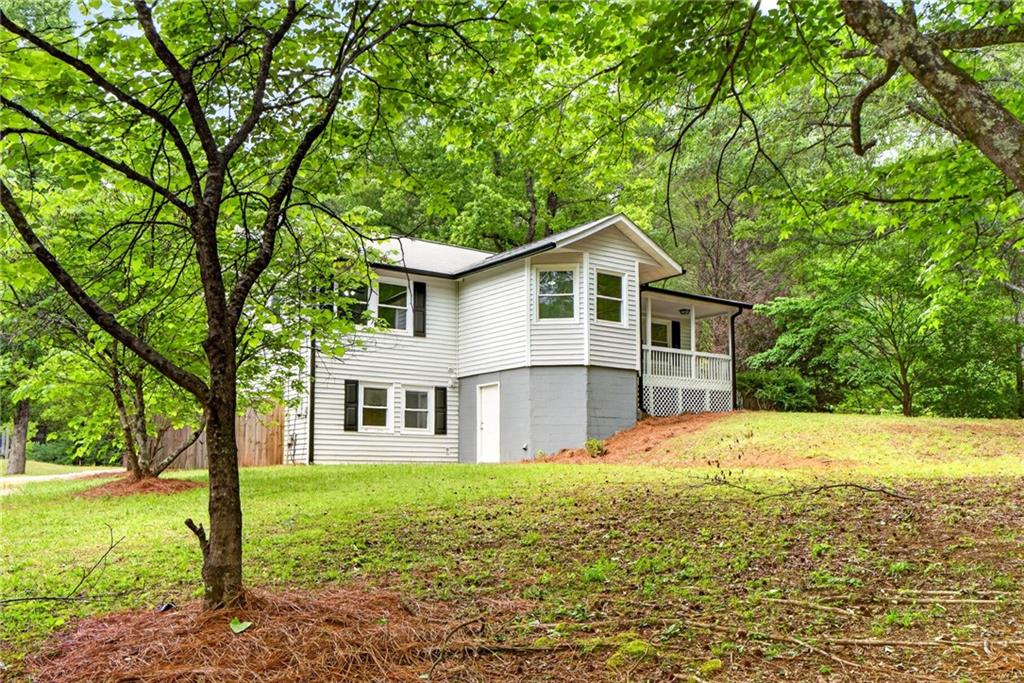 7630 Rico Road Palmetto, GA 30268 - Photo 2 of 53 a front view of a house with a garden