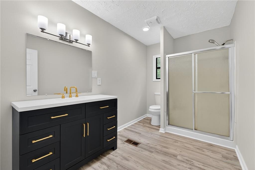 7630 Rico Road Palmetto, GA 30268 - Photo 25 of 53 a bathroom with a sink mirror and a toilet
