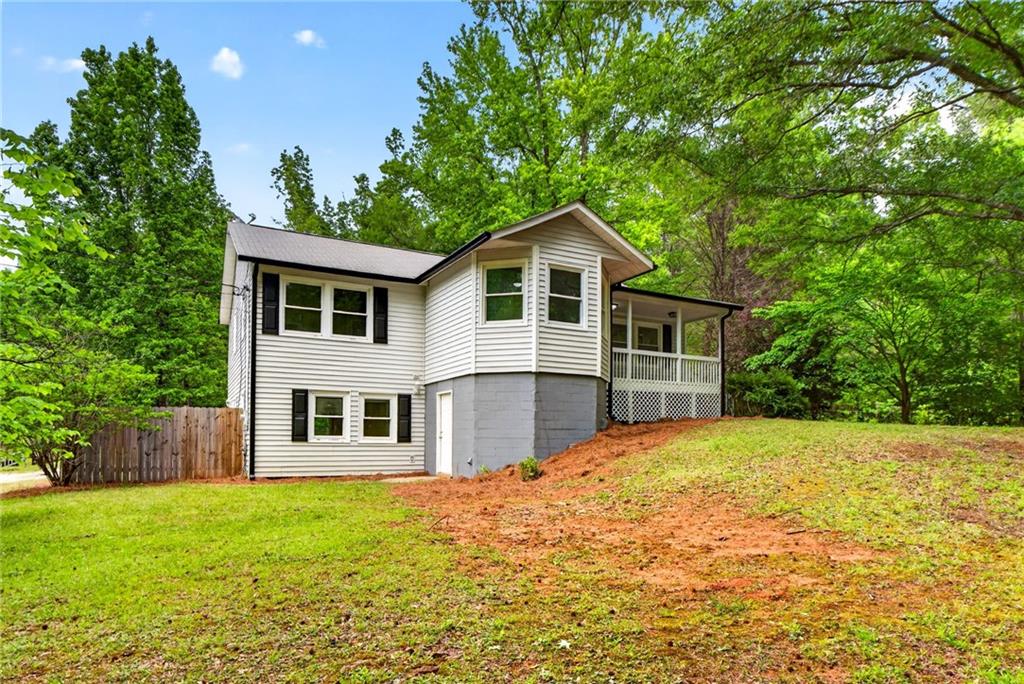 7630 Rico Road Palmetto, GA 30268 - Photo 3 of 53 a front view of a house with a garden