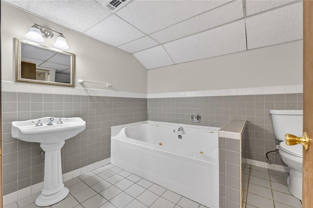 7630 Rico Road Palmetto, GA 30268 - Photo 43 of 53 a bathroom with a sink and bathtub