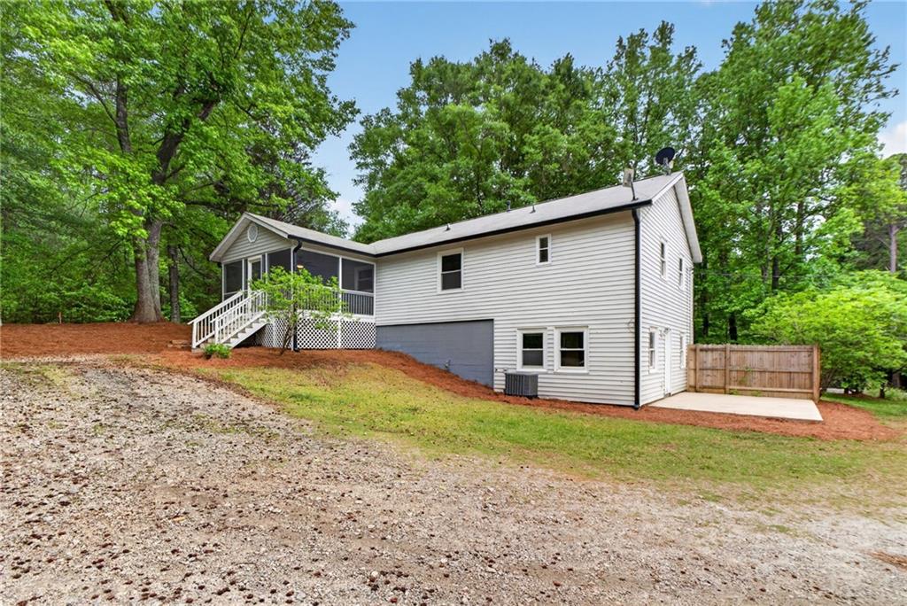 7630 Rico Road Palmetto, GA 30268 - Photo 5 of 53 a view of a house with backyard and trees