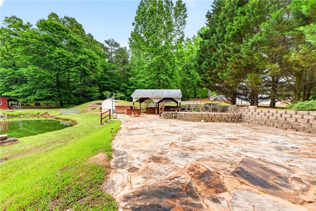 7630 Rico Road Palmetto, GA 30268 - Photo 8 of 53 a view of a swimming pool with a lounge chair