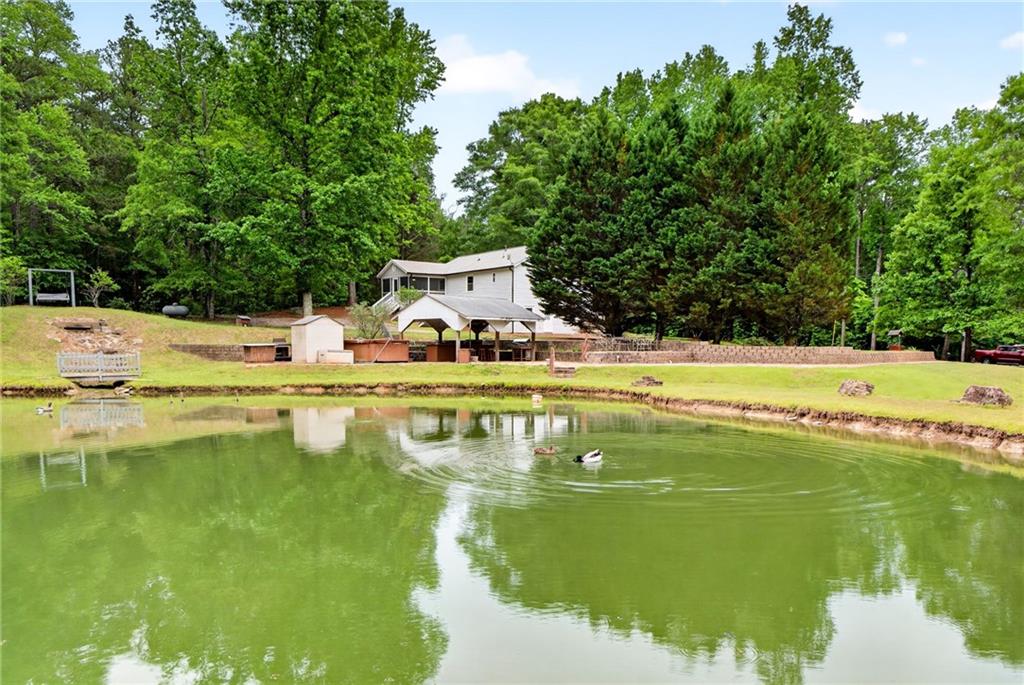 7630 Rico Road Palmetto, GA 30268 - Photo 9 of 53 a view of a swimming pool with a yard
